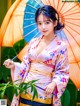 A woman in a kimono holding an umbrella.