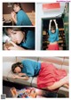 A woman laying on a couch drinking from a glass.